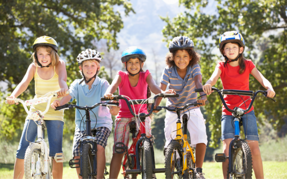 Children on their bikes posing in front of the camera