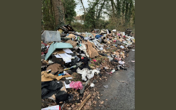 A large pile of the residents belongings at the side of the road