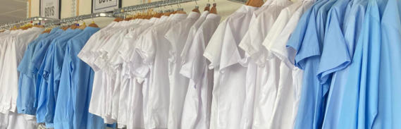 Dozens of school shirts on hangers