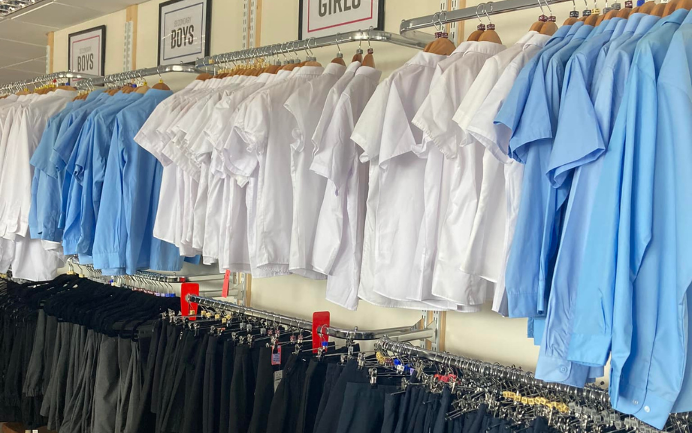 Dozens of items of school uniform on racks for the school uniform sale at First Days