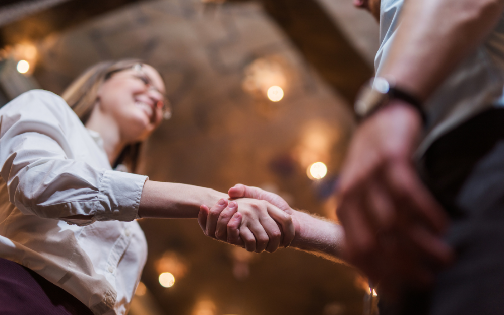 Two peopel shaking hands as they meet for a job interview