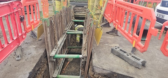 Picture of worker excavating for the drainage system