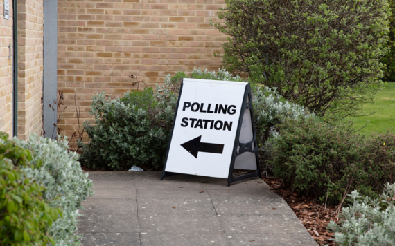 sign in front of a polling station that says 'polling station'