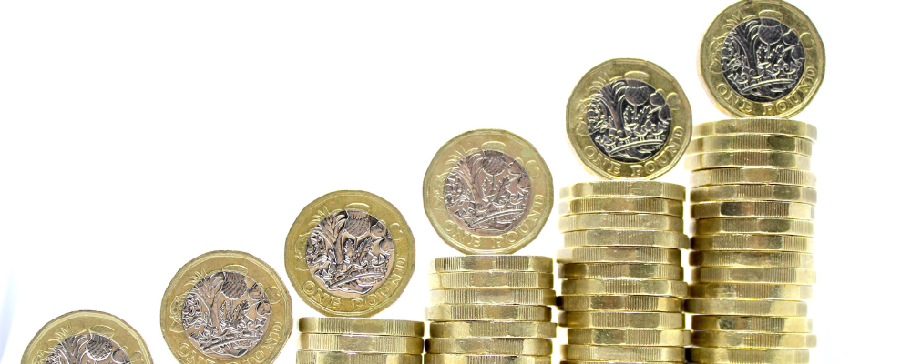 Increasingly tall stacks of £1 coins
