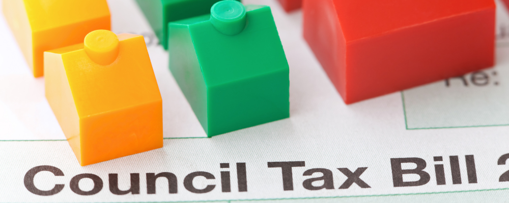 A council tax bill with model houses on it