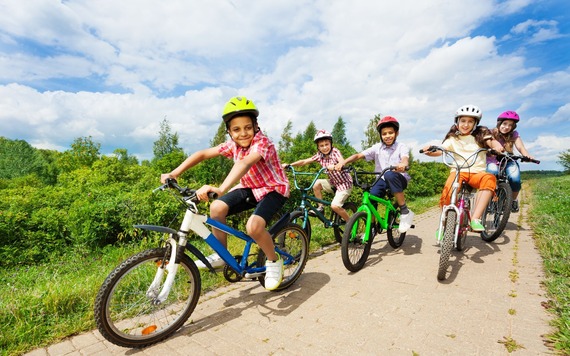 Some boys and girls posing on their bike in the outdoor