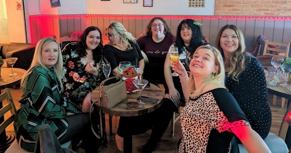 A group of women chatting and having fun while drinking cocktails at Crumbs' Woodley branch