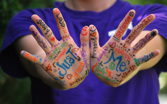 2 hands with positive words written on them about that individual