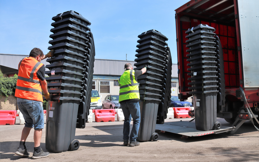 Wheeled bins being unloaded ready for delivery