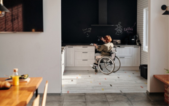 Woman in a wheelchair cooking in a modern kitchen