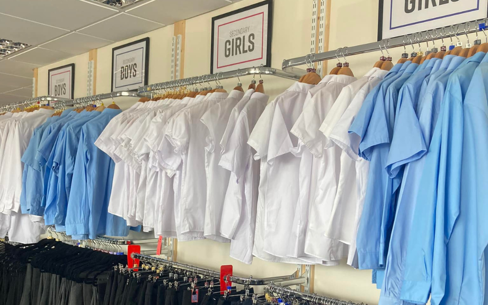 Rows of rails with school shirts, jumpers and dresses at First Days