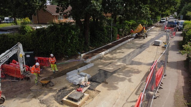 Workmen installing new paving 