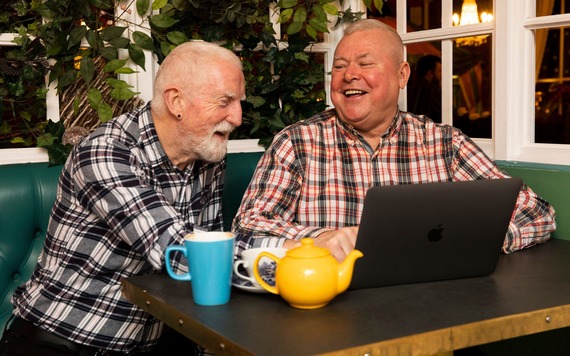Two men looking at a lap top
