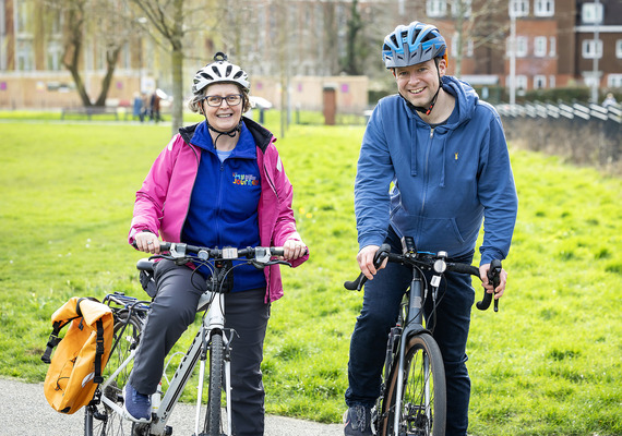 Two cyclists in a park