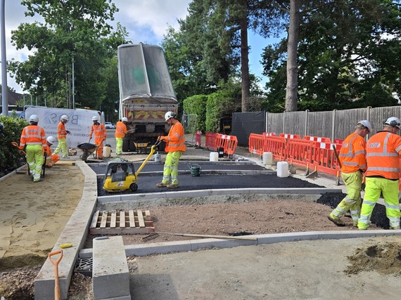 Workers in high viz laying surfacing