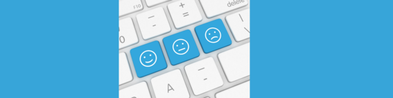Keyboard with three blue keys showing smiling, neutral and sad faces