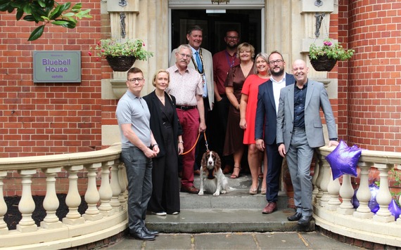 Group of people standing on steps of Bluebell House