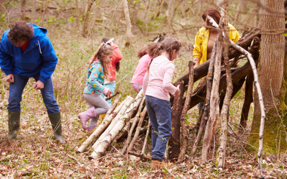 A group of children learning to make shelter in the outdoor