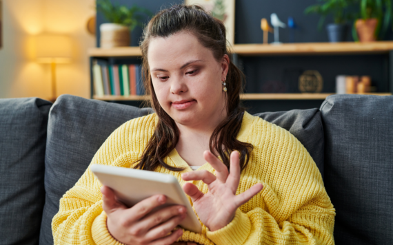 A teenager with Down's syndrome browsing on a tablet