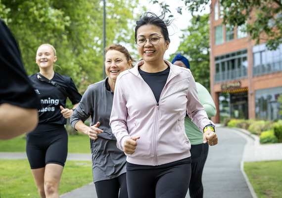Group of ladies running through a park