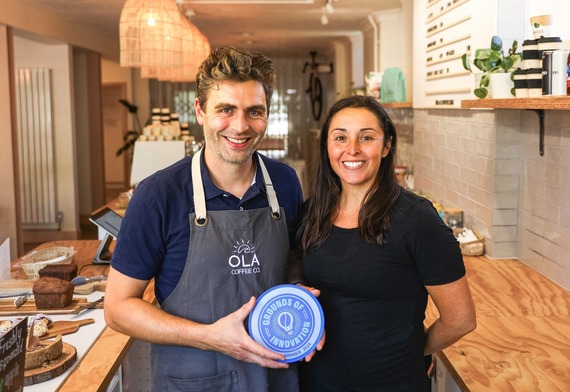 Image of man and woman serving coffee