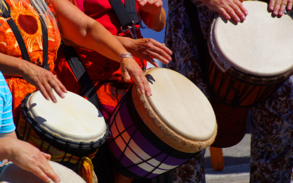 group of people drumming together 