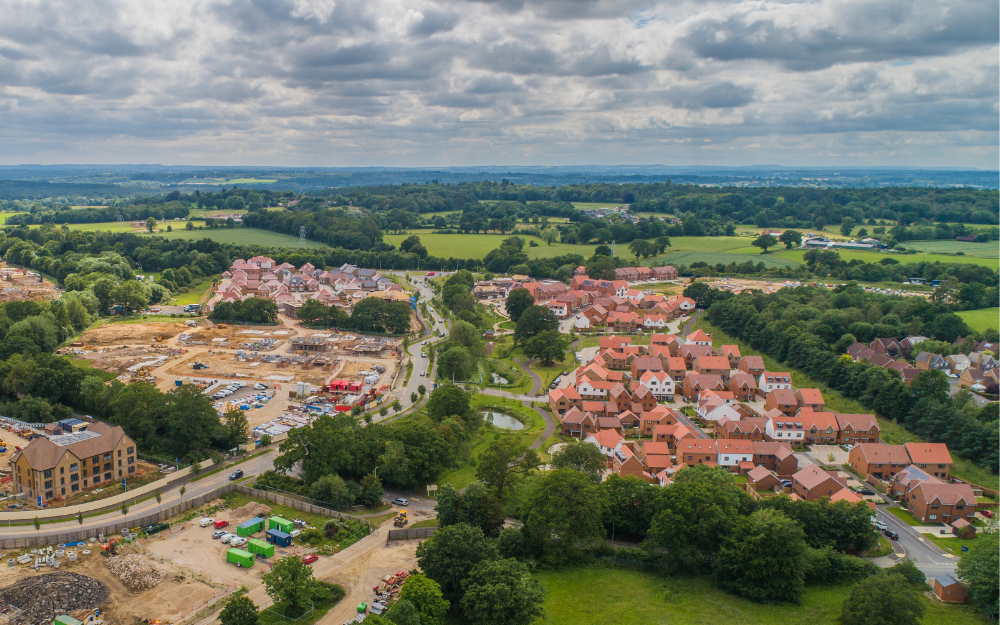 New housing under construction with green space, finished houses and other infrastructure