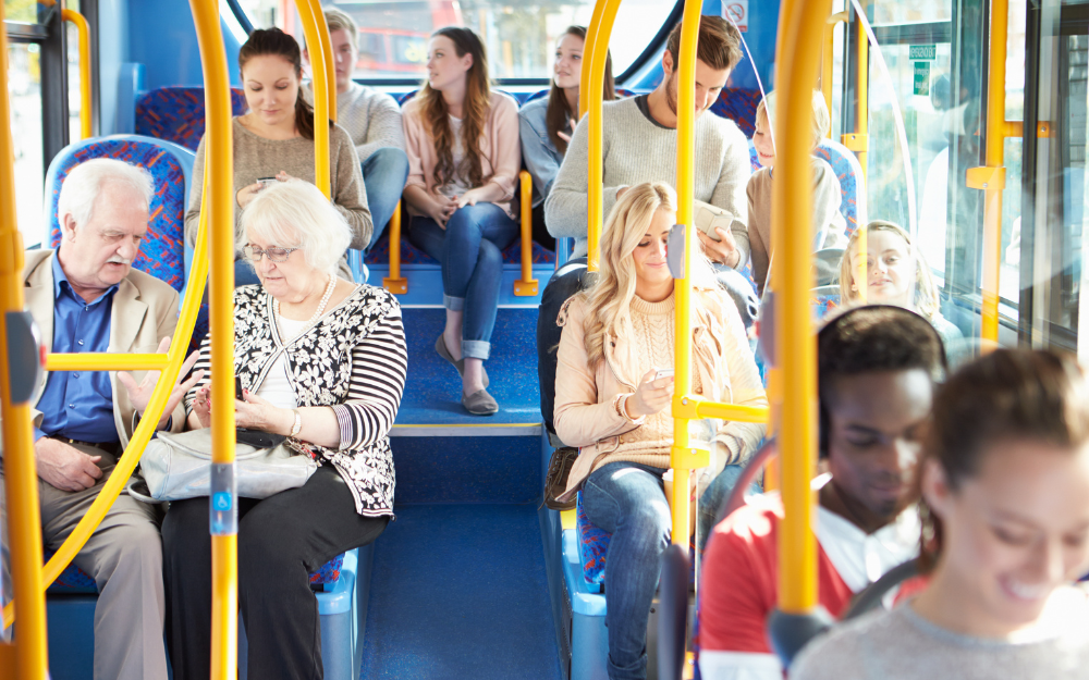A mix of people riding on the bus