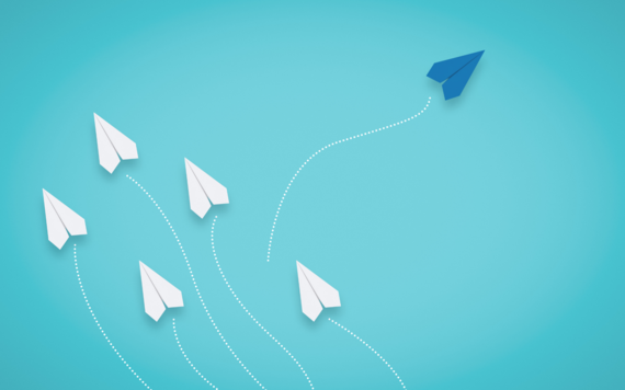 White paper planes fly to the left. One blue plane flys to the right.