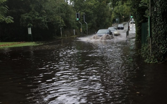 A car driving into a flooded road