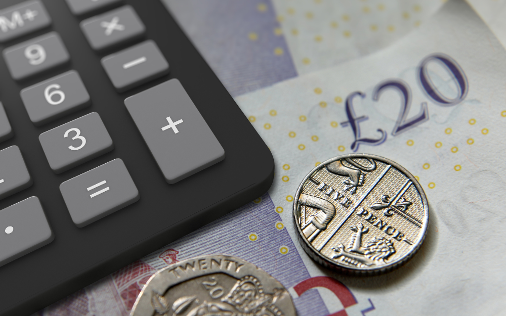 Cash, coins and a calculator on a table