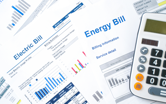 A close-up of some energy bills and a calculator