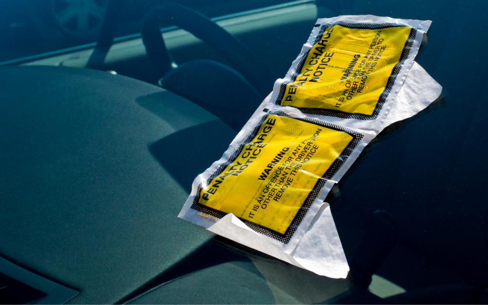 A penalty charge notice on a windscreen of a car