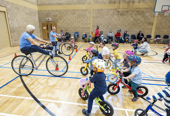 Balance bike club with instructors and children on balance bikes