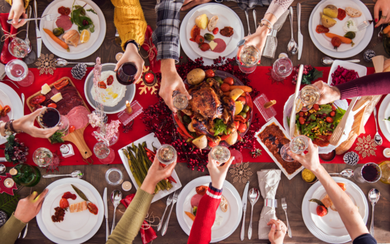 A top view of a Christmas meal table with lots of food and drink