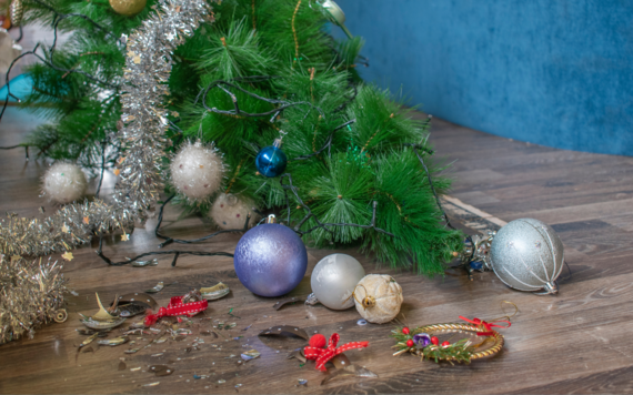 Christmas tree on its side with baubles on the floor