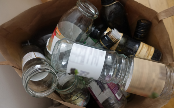 A top view of a bag of glass jars and bottles