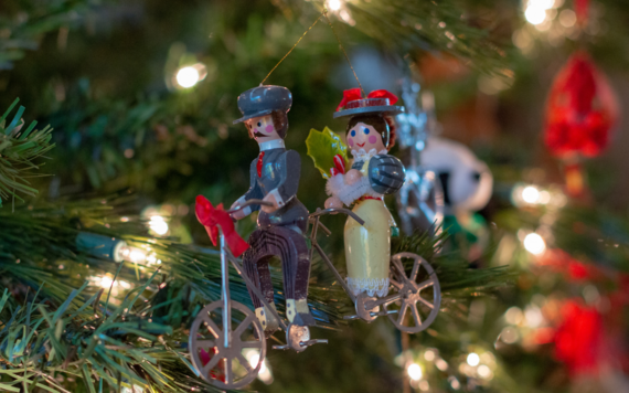 Christmas ornament hanging on a tree of two people on a bike