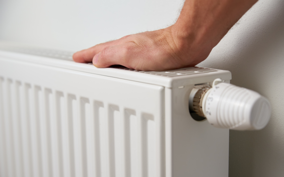 Hand touching top of radiator