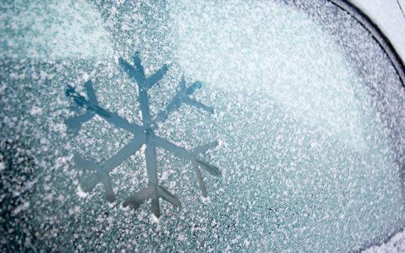Ice on a car windscreen with the frost symbol