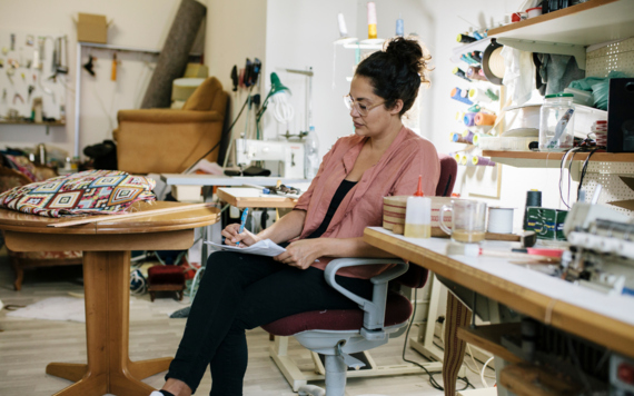 A female small business owner doing paperwork in her studio