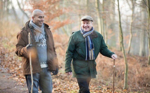 Two men walking in woodland