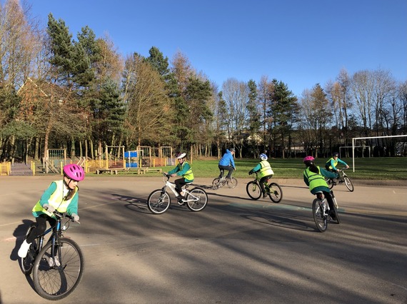 Group of children taking part in cycle training in school