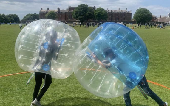 Two people play a bubble football game