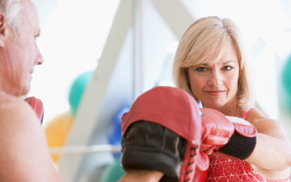 Woman wearing boxing gloves at a boxercise gym class