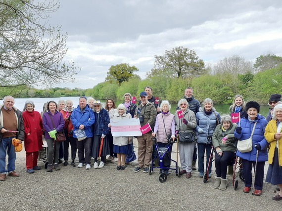 Group of people standing in front of a lake