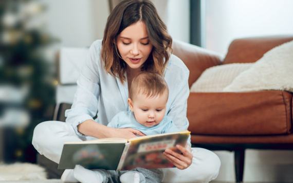 Mum reading book to baby