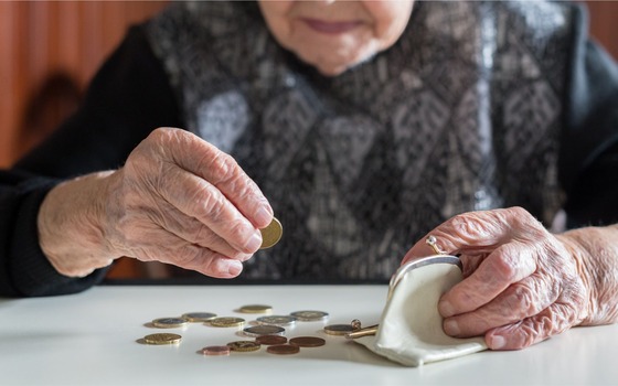 elderly person with coins