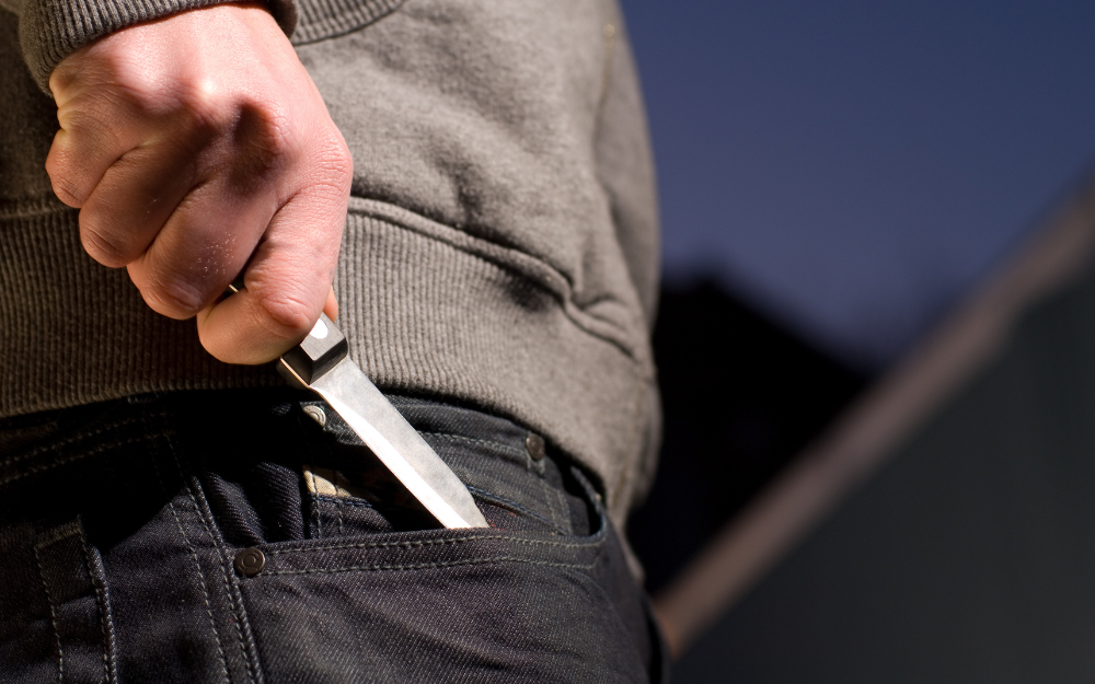 A man pulls a knife out of his pocket