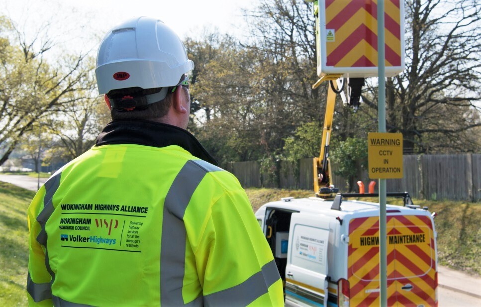 View from behind of a Volker operative in a branded high vis vest